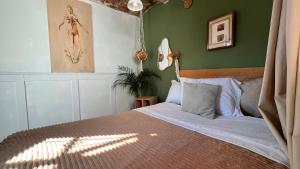 a bedroom with a bed and a green wall at Galerie Guanajuato Centro in Guanajuato +11 photos
