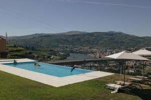 a swimming pool with a view of a city at Quinta do Roso - Douro Wine Estate - by FERO in Lamego