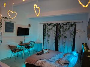 a bedroom with a bed and a table and chairs at escapade coeur provence in La Celle