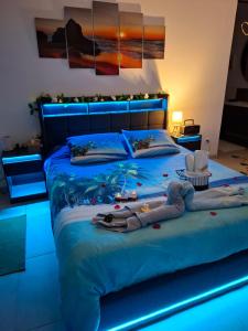 a bedroom with a blue bed with a fish blanket and a hat at escapade coeur provence in La Celle