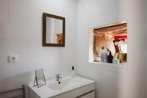 a white bathroom with a sink and a mirror at Douro Feels Like Home in Fontelo +21 photos