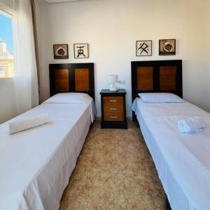 two beds sitting next to each other in a room at Casa Kave Euro Roda-Los Alcazares in Los Alcázares +10 photos