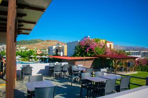 a group of tables and chairs on a patio at Nereides Hotel in Kolymvari