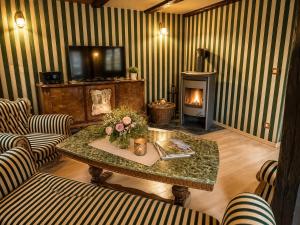 a living room with a table and a fireplace at Alte Faktorei Schierke in Schierke