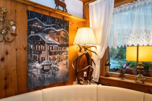 a living room with a couch and a window at Hotel Garnì La Montanara in Madonna di Campiglio +57 photos