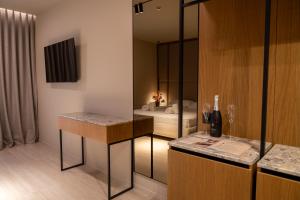 a room with a bedroom with a bed and a mirror at South Inn Marina Hotel in Vlorë +110 photos