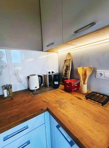 a kitchen with a wooden counter top with appliances at Domek nad Oczkiem Wodnym in Giżycko +12 photos
