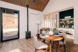 a living room with a table and chairs and a bedroom at Lakay Monteverde with Heated Pool, Golf Cart and Breakfast in Monteverde Costa Rica