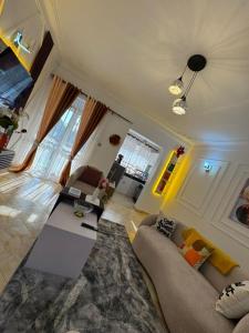 a living room with a couch and a table at LYZ HOMES Ltd in Kampala
