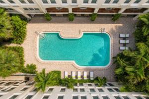 an overhead view of a swimming pool at a resort at 1BR Retreat with Private Terrace in Palm Beach
