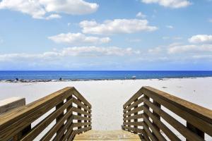 a wooden staircase leading to a beach with the ocean at 1BR Retreat with Private Terrace in Palm Beach