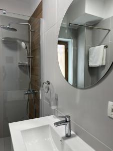 a bathroom with a sink and a mirror at FAME Apartment - Permet in Përmet +19 photos