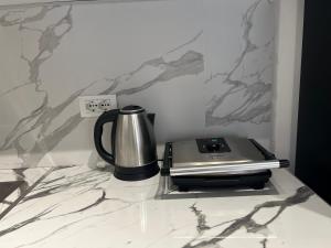a coffee pot sitting on top of a counter at FAME Apartment - Permet in Përmet