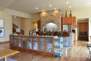 a large kitchen with a stone fireplace in a room at Corbin B&B in Corvallis