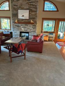 a living room with a couch and a fireplace at Corbin B&B in Corvallis
