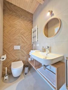 a bathroom with a sink and a toilet at Morze Las in Ustka +31 photos