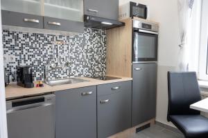 a kitchen with a sink and a stove top oven at Paky Appartements 00210 in Vienna