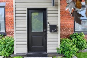 a black door on the side of a house at The 1883 Century Flat Suite in Collingwood