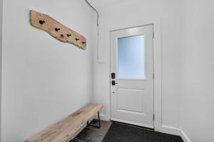 a room with a door and a bench at The 1883 Century Flat Suite in Collingwood +38 photos