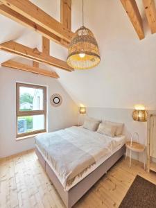 a bedroom with a large bed and a window at Morze Las in Ustka
