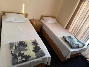 a bedroom with two beds and a window at Prince hotel in Tashkent