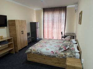 a bedroom with a bed and a television in it at Prince hotel in Tashkent