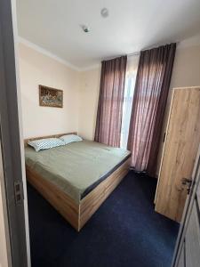 a bedroom with a bed and a window at Prince hotel in Tashkent