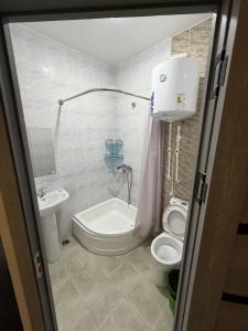 a bathroom with a toilet and a sink at Prince hotel in Tashkent