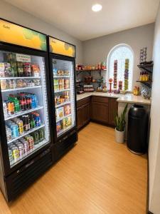 a kitchen with an open refrigerator with drinks in it at Quality Inn & Suites Sequim at Olympic National Park in Sequim