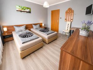 a living room with two beds and a table at Pension Reiter in Blomberg