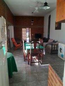 a living room with a green table and chairs at Graciela in Villa Las Rosas