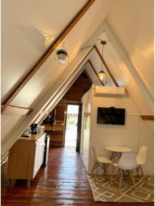 an attic kitchen and dining room with a table and chairs at Boquete Firefly Inn in Boquete
