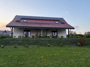 a house with solar panels on the roof at Białe Żagle Mazury in Węgorzewo