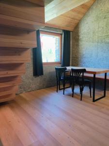 a dining room with a table and chairs and a window at RISTORO TANEDA in Quinto