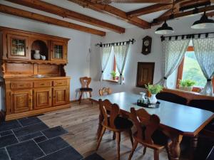 a dining room with a wooden table and chairs at Haarstubenhäusl Glückskäfer in Frankenfels +26 photos