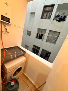 a washing machine in a room with a building at Appartement Nadin in Martil