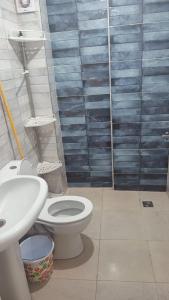 a bathroom with a toilet and a sink at Naders in Tangier