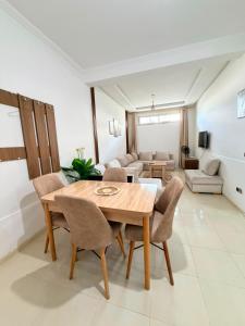a dining room table and chairs in a living room at Naders in Tangier