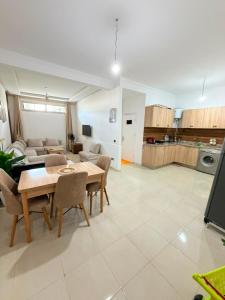 a kitchen and living room with a table and chairs at Naders in Tangier