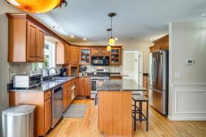 a kitchen with wooden cabinets and stainless steel appliances at Heated Pool, 6 Acres: Beacon Area Vacation Rental in Lagrangeville