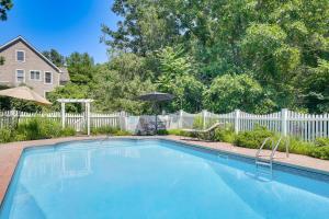 a swimming pool in a yard with an umbrella at Heated Pool, 6 Acres: Beacon Area Vacation Rental in Lagrangeville