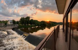 a view of a river from a balcony at sunset at Viešbutis Banga in Tauragė