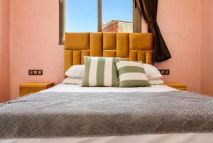 a bedroom with a large bed with a large headboard at House Aisha Rooftop Hostel in Aourir