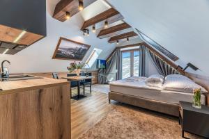 a kitchen and a bedroom with a bed in a room at Penzión Šafrán in Ždiar