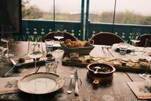 a table with a plate of food and a basket of food at Togonidze's Wine Cellar in Telavi +36 photos