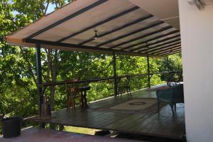 a deck with awning and a table and chairs at Togonidze's Wine Cellar in Telavi