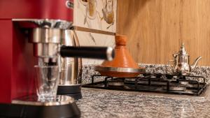 a kitchen counter with a coffee pot on a stove at House Aisha Rooftop Hostel in Aourir