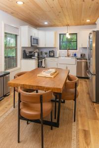 a large kitchen with a wooden table and chairs at S'more Memories-Cold Plunge, Sauna, Hot Tub Wellness Retreat in Campton