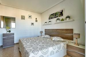 a bedroom with a bed with a white bedspread at Espanhouse Vera Torreblanca in Torrevieja