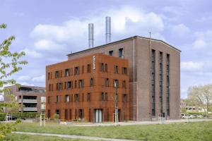 a brick building with two smoke stacks on top at ipartment Leverkusen @HOME by Best Western in Leverkusen